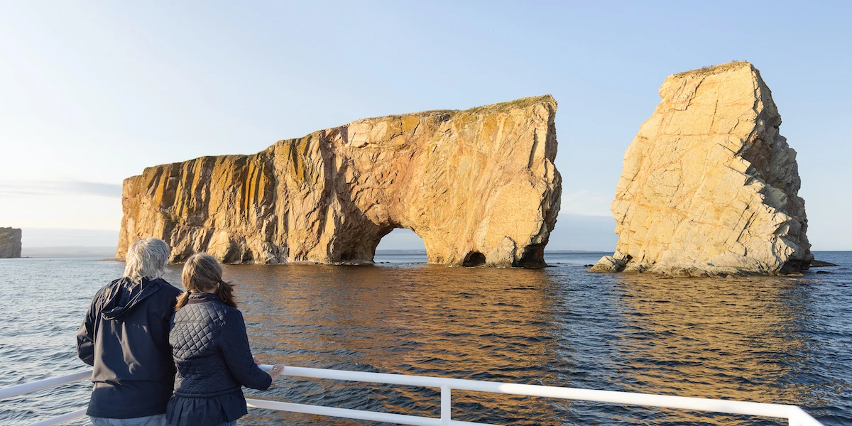 Percé Rock: The Complete Visitor's Guide to Quebec's Pierced Sea Stack 1 Percé Rock at sunrise with golden light illuminating the natural arch